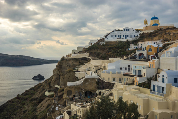 White city on a slope of a hill in Oia, Santorini, Greece - Photo, Image