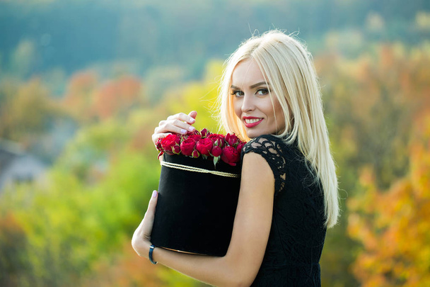 Pretty girl with flowers in box - Zdjęcie, obraz