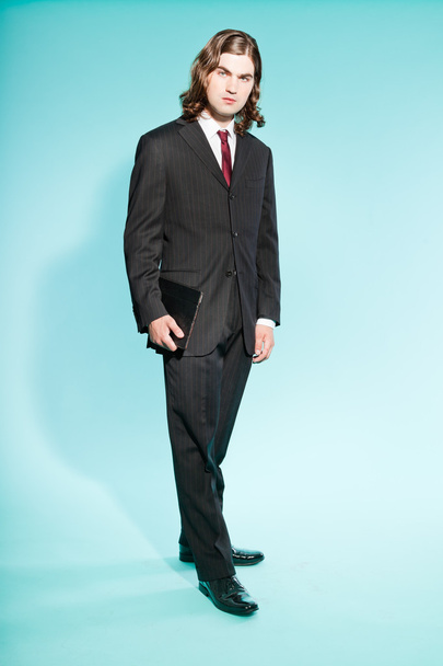 Cool business man with long brown hair confident looking. - Фото, зображення