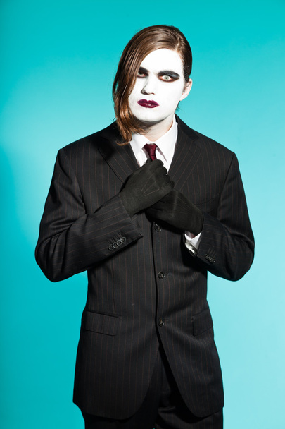 Gothic Vampir aussehender Geschäftsmann mit schwarz gestreiftem Anzug und dunkelroter Krawatte. - Foto, Bild