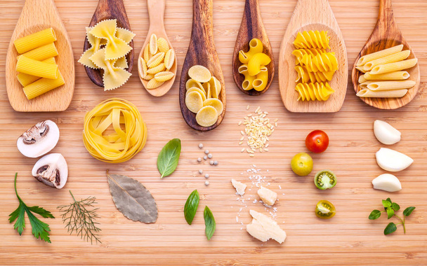 Italian food concept .Various kind of pasta in wooden spoons wit - Fotoğraf, Görsel