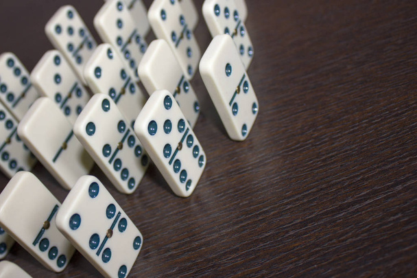 Dominoes on background wooden table - 写真・画像