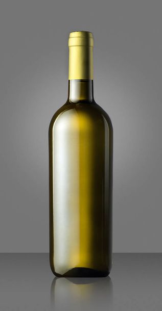 Single unlabelled green white wine bottle on grey - Photo, image