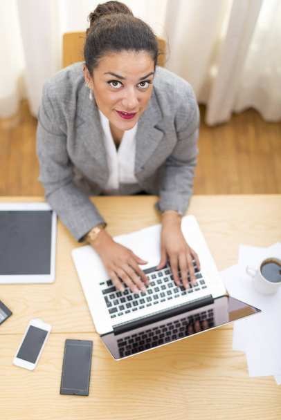 High angle view on enjoying businesswoman typing on laptop compu - Zdjęcie, obraz