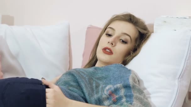 Smart girl relaxing, lying and posing on the bed. Slowly - Felvétel, videó