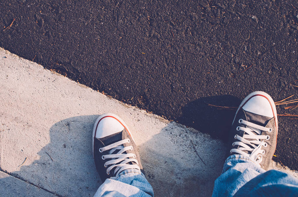 Top view of shoes and blue jean on street, selfie. - Фото, зображення