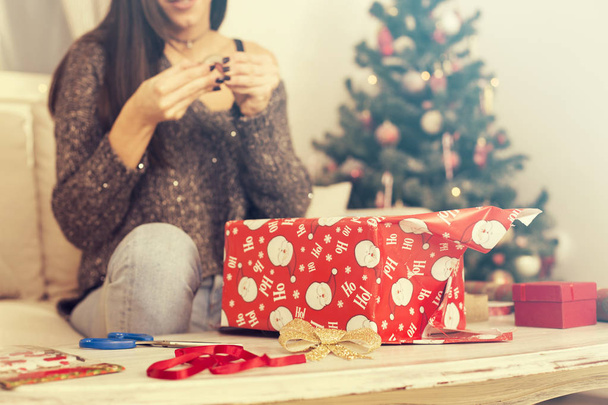 Happy Woman Wrapping Christmas gifts - Фото, изображение