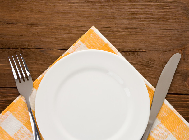 plate, knife and fork on wood - Fotoğraf, Görsel