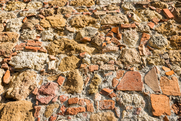 Close up view of an aged textured stone wall - Photo, Image