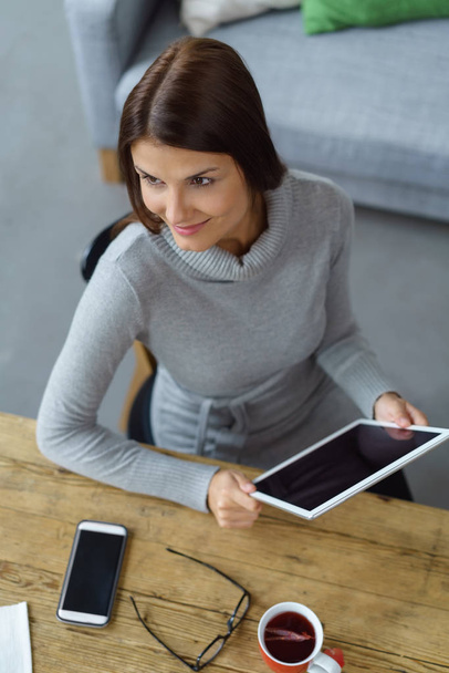 Pretty young businesswoman holding a tablet - Photo, image