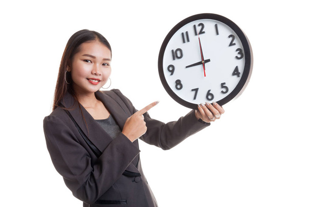Young Asian business woman point to a clock. - 写真・画像