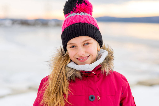 Young girl on the frozen lake - Фото, зображення