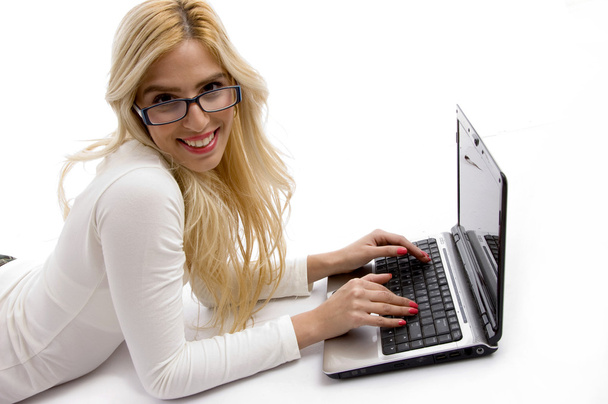 Miling young female working on laptop - Photo, Image
