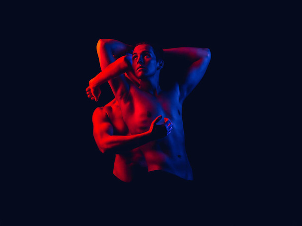 Fashion collage art photo of two athletic men. Set of art photo of strong young athletic men in red and blue colors on isolated dark background in colored spotlights. Narcissism concept. - Zdjęcie, obraz