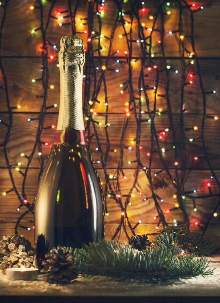 Новогодняя композиция с бутылкой шампанского и огнями
 - Фото, изображение