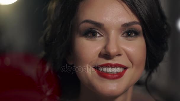 Portrait of amazing beautiful girl with red lips close-up. Happy woman smiling snow-white smile. - Felvétel, videó