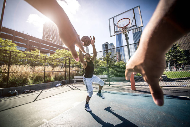 Basketball players playing on court - 写真・画像
