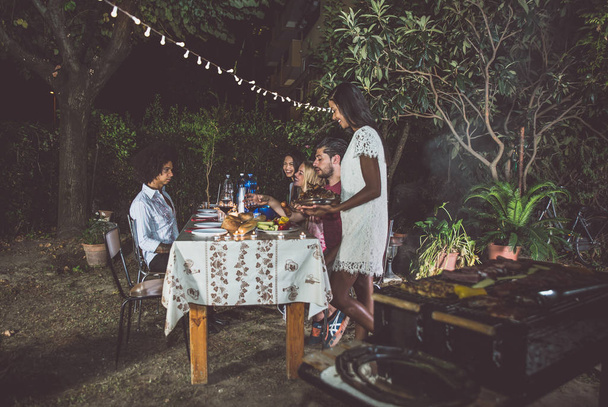 Friends making barbecue in backyard - Photo, image