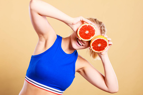 Woman holding grapefruit citrus fruit in hands - Φωτογραφία, εικόνα