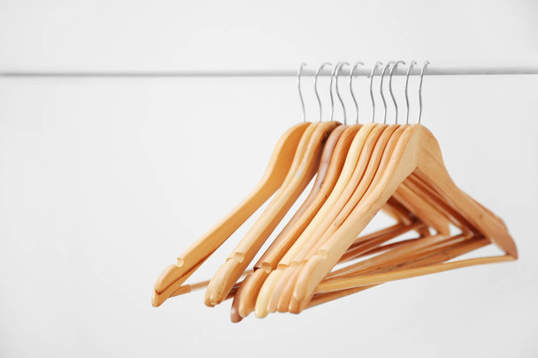 Wooden coat hangers on clothes rail - Fotoğraf, Görsel