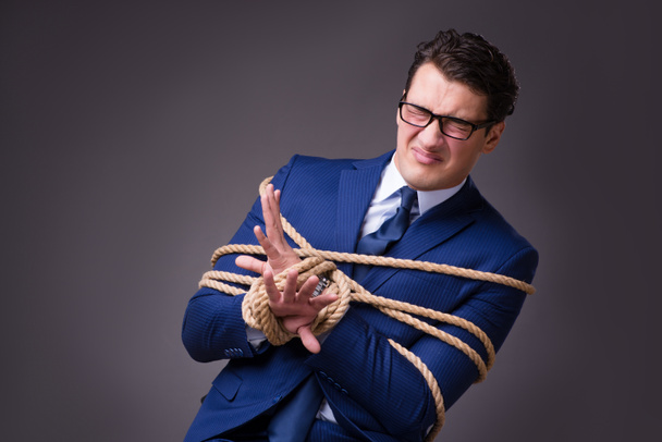 Businessman tied up with rope - Foto, Bild