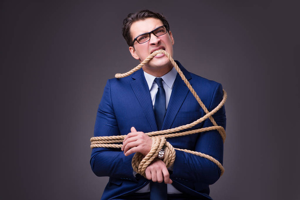 Businessman tied up with rope - Photo, Image