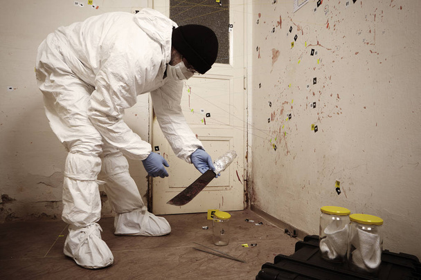 Taking care of odor traces by police technician on location - 写真・画像