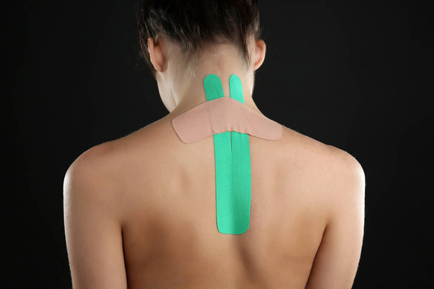 Female back with physio tape  - Фото, изображение