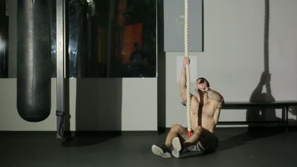 Fitness Rope Climb Exercise In Fitness Gym Workout. young male athlete - Video, Çekim