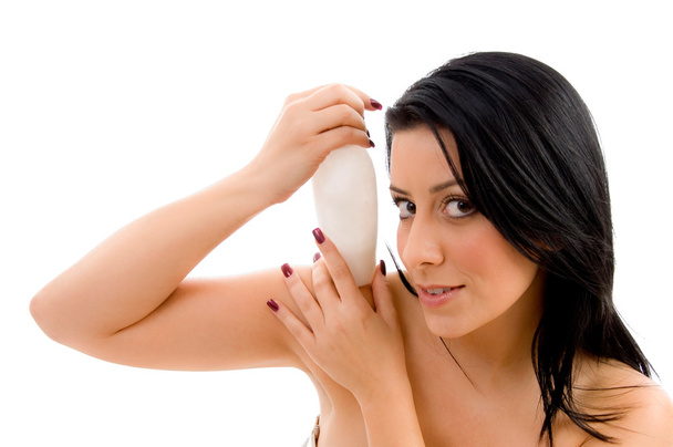 Portrait of young female holding lotion - Foto, immagini