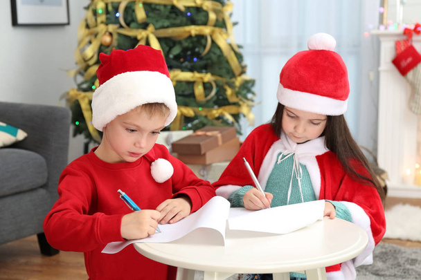Cute little kids writing letter to Santa Claus at table - Valokuva, kuva