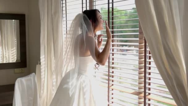 Smiling bride near window. - Footage, Video