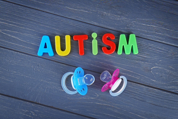 Word AUTISM with pacifiers  - Foto, Imagem