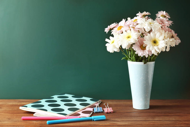 Copybooks and flowers on desk - Foto, immagini
