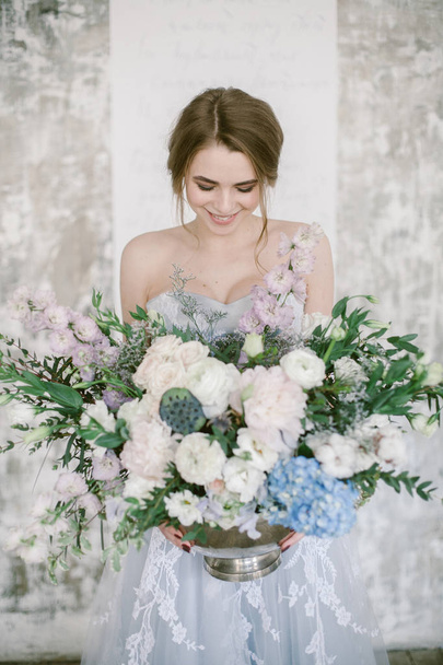 Beautiful floral composition in hands of young bride. - Foto, Imagem