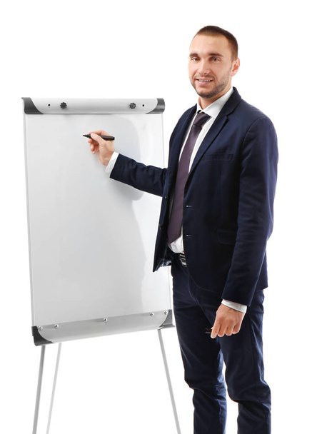 Young businessman standing near flip chart - Valokuva, kuva