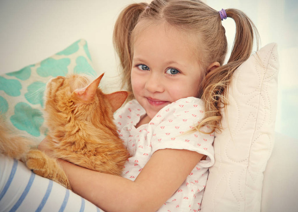 Cute little girl with red cat - Foto, immagini