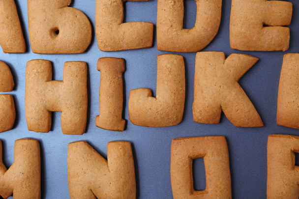 Cookie alphabet on dark background, closeup - Foto, afbeelding