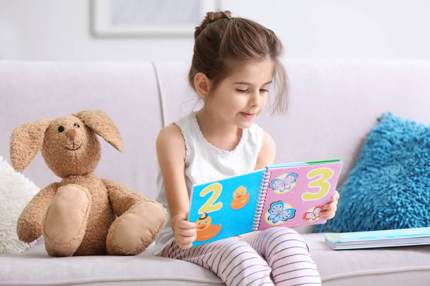 Funny little girl reading book  - Foto, imagen
