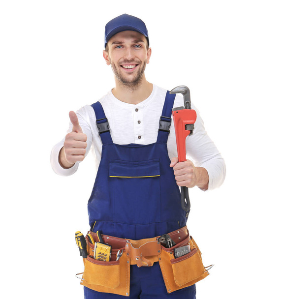 Smiling plumber holding screw-wrench  - Foto, afbeelding