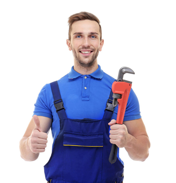 Smiling plumber holding screw-wrench  - Foto, immagini