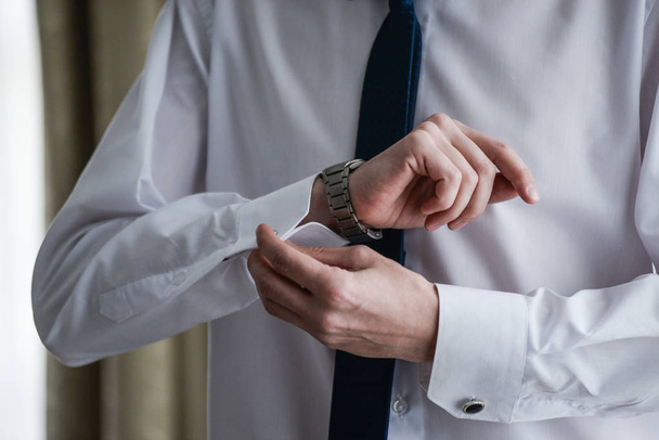man in a tux fixing his cufflink - Photo, Image