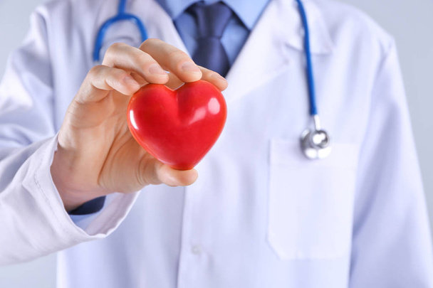Male doctor hand holding red heart - Foto, Imagem