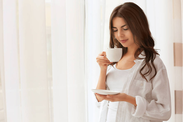 woman with cup of aromatic coffee  - Фото, зображення