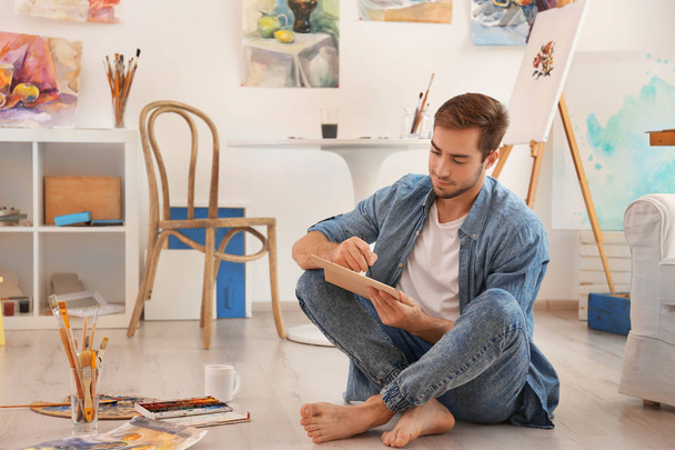 Young male artist painting - Photo, image