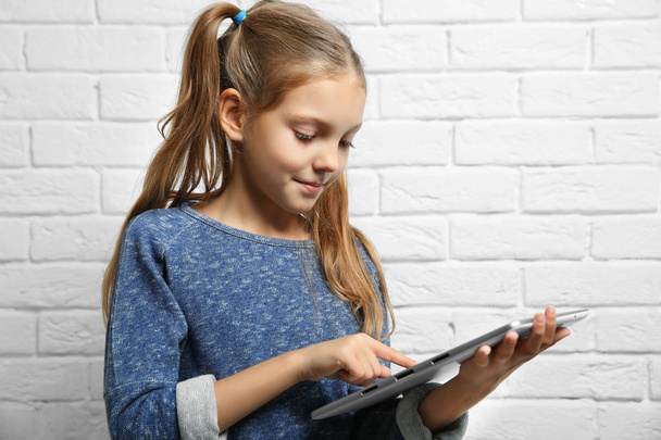 Cute girl with tablet  - Фото, изображение