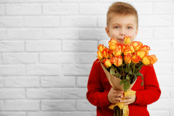 boy with bouquet of beautiful flowers - Foto, Imagen