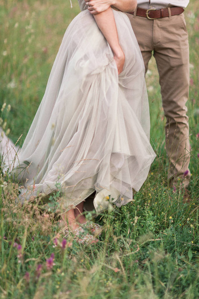 Couple in wedding attire with a bouquet of flowers and greenery  - Foto, Imagem