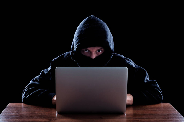 Hooded computer hacker stealing information - Foto, Imagem