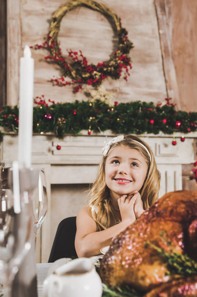 Cute girl at holiday table     - 写真・画像